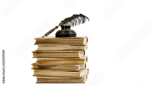 Isolated stack of antique books with a vintage quill pen and inkwell on top