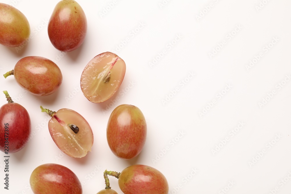 Fototapeta premium Fresh ripe grapes on white background, flat lay. Space for text