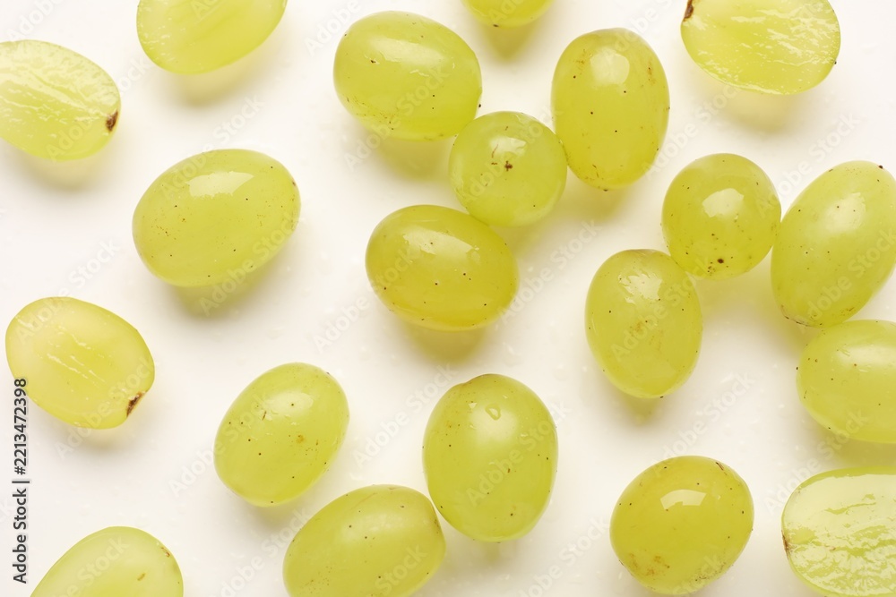 Fototapeta premium Fresh ripe grapes on white background, flat lay