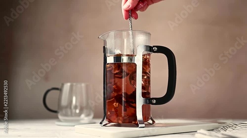 Brewing warm herbal tea in french press, cozy autumnal worm drink