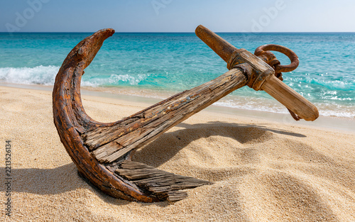 Vintage Admiralty Anchor on a Sunny Sandy Beach with Ocean Waves