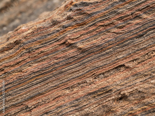 Macro view of naturally layered sedimentary rock with colorful strata