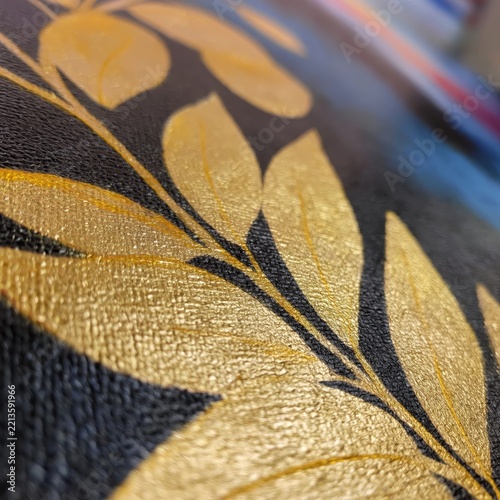 Golden Leaf Design on a Dark Surface With Colorful Background