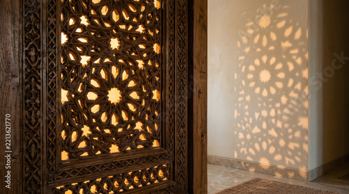 Ramadan decorative screen casting intricate geometric light patterns