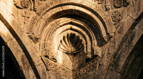 Ancient stone archway with intricate Islamic architectural carvings
