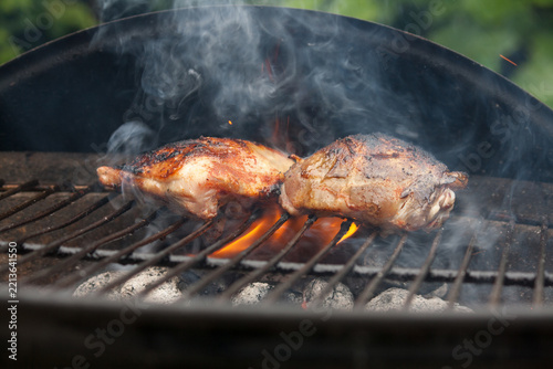 Chicken breast laying in the flames on barbecue