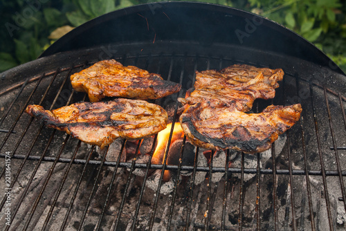 Grilling a juicy steak in the flames of a coal barbecue