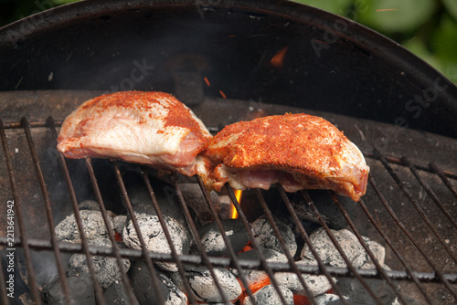 Chicken breast laying in the flames on barbecue