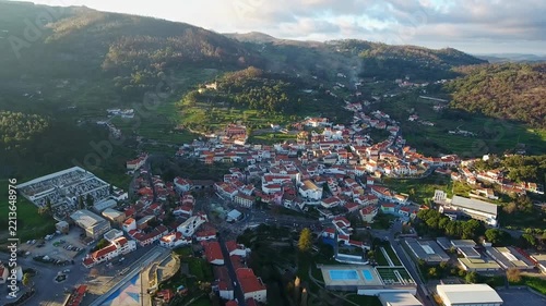 Majestic aerial view of the historic town of monchique nestled in the green mountains of the algarve region in portugal, beautifully illuminated by the warm light of the setting sun