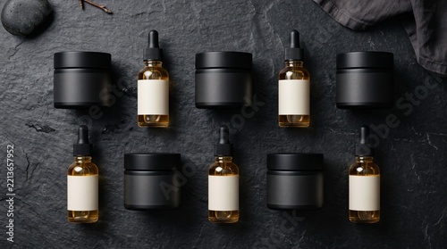 Skincare Dropper Bottles and Black Cosmetic Jars on Slate Background for Beauty Packaging Mockup