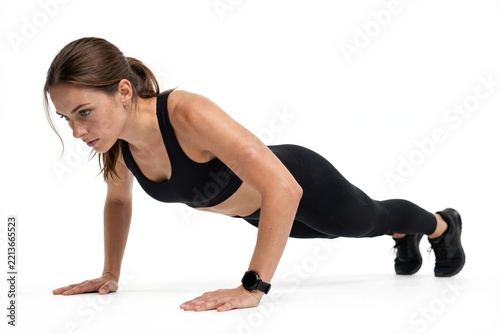 Athletic Woman Performing Push Up Exercise Isolated on White Background for Upper Body Strength and Core Fitness