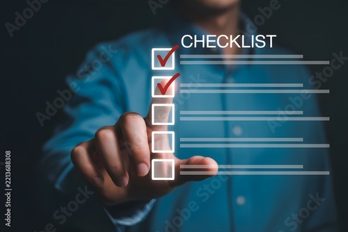 Professional hand touches a holographic checklist, marking completed tasks and showcasing efficient business management solutions