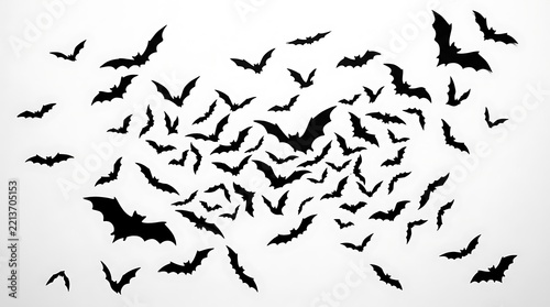 Black Halloween bats swarm in a chaotic flight pattern isolated on white background macro photography