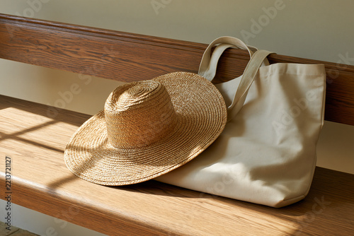 Straw hat and beach bag in sunlight