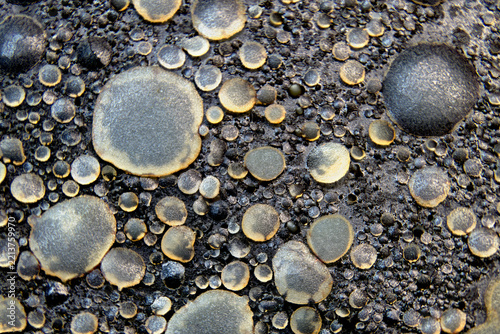 Congealed grease macro texture with dark granular residue