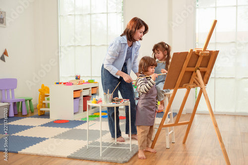 Asian Mother Teaching Children Painting and Creative Art at Home