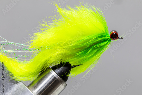 Chartreuse streamer fly on a tying vice ready to take fishing for steelhead