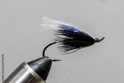 Traditional hilton fly on a tying vice ready to take fishing for steelhead