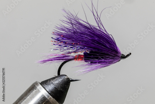 Purple haze streamer fly on a tying vice ready to take fishing for steelhead
