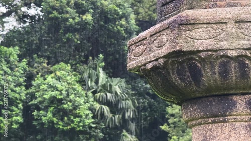 Close-up of a Rain-Wet Stone Lantern in a Traditional Japanese Garden