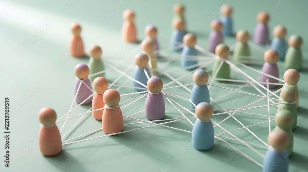 Obraz premium Wooden pegs connected by string symbolizing networking communication teamwork