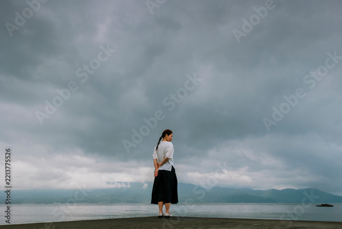 A Woman Contemplating by the Sea Before a Storm