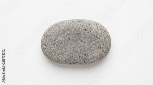 single smooth natural gray river stone pebble isolated on white background