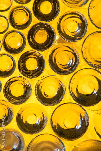 Macro view of handmade yellow glass plate with circular bumps