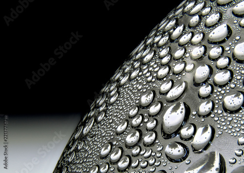 Water droplets on curved plastic surface in macro closeup