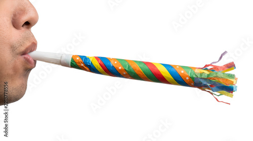 Close-up of a person blowing a colorful striped party blower for a celebration on a transparent background