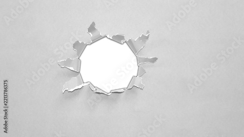 Gray circular ripped paper cutout with ragged fibrous border and transparent center, realistic torn paper frame for collage and layout design