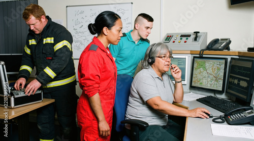 Emergency dispatch team coordinate response in control room