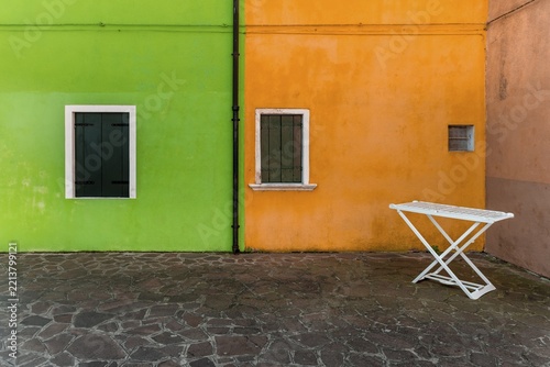 Clothes horse, green and orange wall, colorful house wall,window with closed shutters, colorful facade, Burano Island, Venice, Veneto, Italy