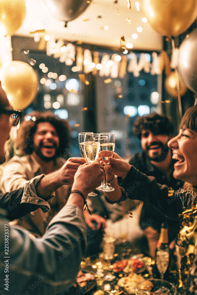 Fototapeta premium Friends Toasting at a New Year’s Eve Party