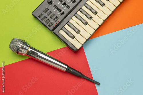 Colorful Musical Composition with Keyboard and Microphone on Vibrant Background