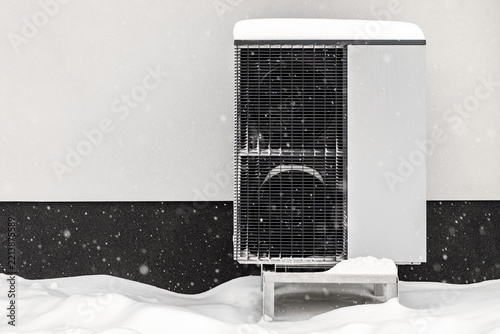 Outdoor Heat Pump Unit Operating in Heavy Snowfall in Winter