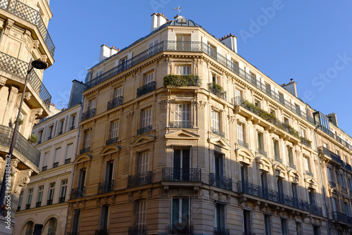 Corner facade of a Haussmann-style Parisian building with wrought-iron balconies and mansard roof near Orsay museum , 7th arrondissement, Paris, France