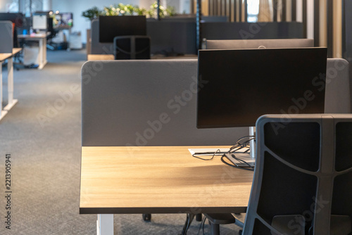 Saint Peterburgs, Empty modern open-plan office with computer monitors, desks, ergonomic chairs partitioned workstations.