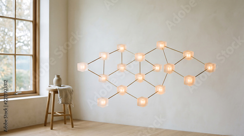 A minimalist scandinavian interior featuring a geometric wall-mounted light fixture with glowing glass orbs connected by thin metal rods, next to a wooden stool and a window