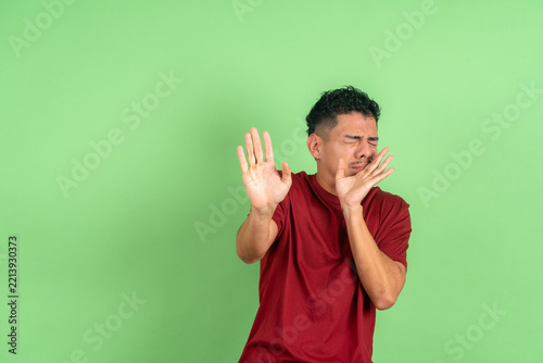 Obraz na plátně Young adult man showing disgust and aversion