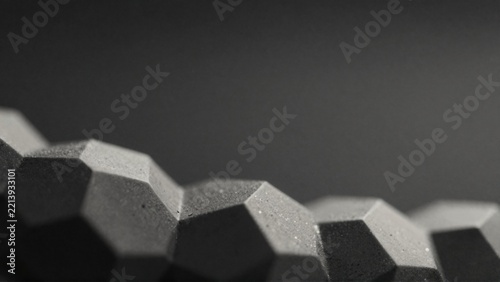 close group hexagonal objects objects arranged way overlapping creating sense depth dimension background solid black color making hexagons stand out even more black white giving monochromatic tone