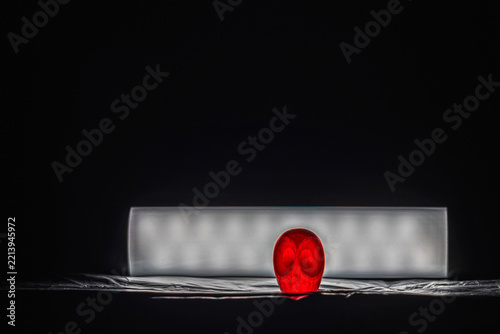 Glowing red owl figurine next to a light strip