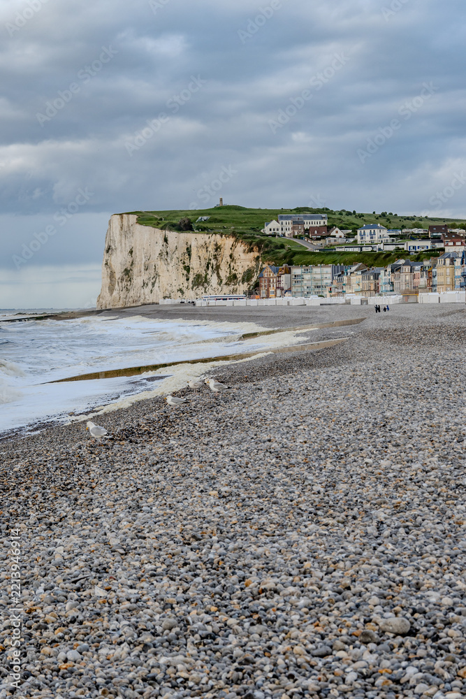 Fototapeta premium Mers-les-Bains, seaside town with 19th-century sea-bathing villas with colorful wooden balconies and white chalk cliffs, tourists destination in France