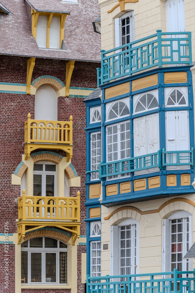 Fototapeta premium Houses of Mers-les-Bains, seaside town with 19th-century sea-bathing villas with colorful wooden balconies and white chalk cliffs, tourists destination in France