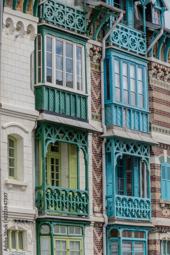 Fototapeta premium Houses of Mers-les-Bains, seaside town with 19th-century sea-bathing villas with colorful wooden balconies and white chalk cliffs, tourists destination in France