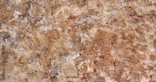 Slider Motion Across Weathered Beige Rock Texture with Natural Cavity, Cracks and Eroded Stone Surface