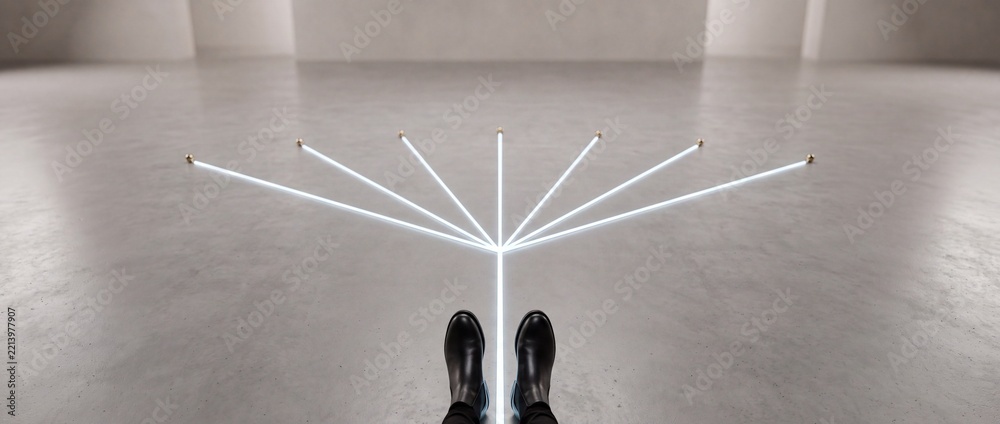 Fototapeta premium Conceptual first person view of a person in black boots standing at a junction of branching glowing white lines on a concrete floor, symbolizing choice, strategic paths, and future possibilities.