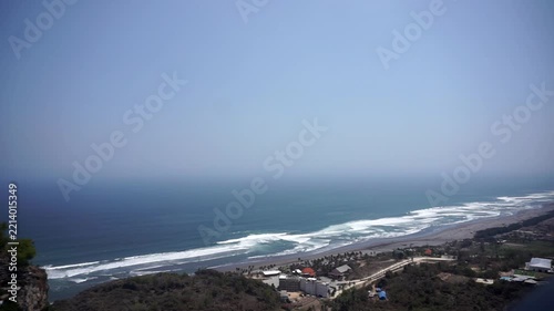 Hilltop timelapse footage showing the movement of Indian Ocean tropical sea waves and the coastal landscape of Yogyakarta.