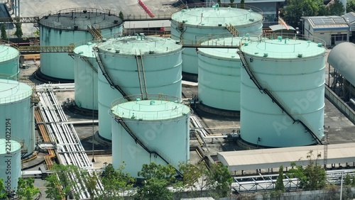 Aerial drone view of large oil storage tanks and industrial pipelines, highlighting modern energy infrastructure, resource management, and environmental considerations in today’s global economy. 4k.
