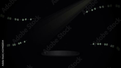 A single narrow beam of intense light illuminates the center of a dark area where decorative strands of tiny glowing bulbs hang gracefully to create a dramatic atmosphere for a luxury